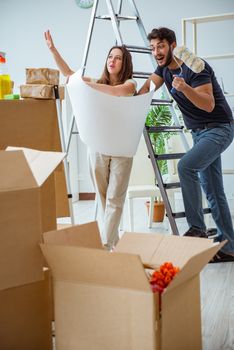 Young family unpacking at new house with boxes