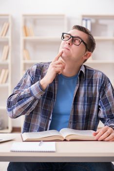 Young student preparing to school exams with books