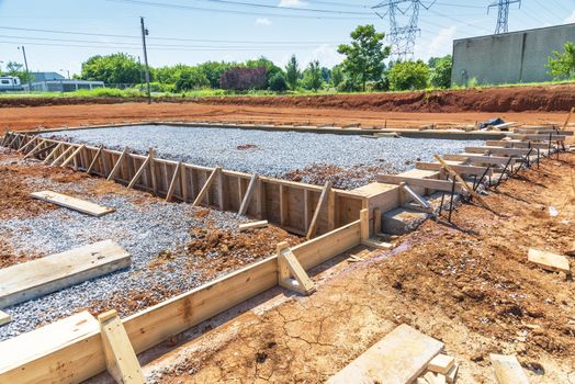 Horizontal shot of boards assembled at a construction site for pouring a concrete slab.