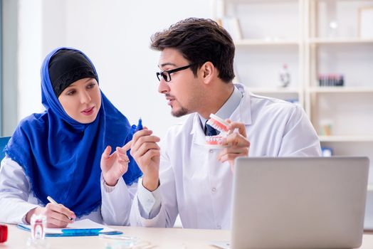 Dentist doctor and assistant working on new tooth implant