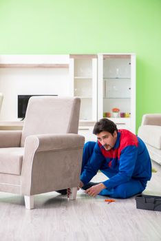 Repair contractor repairing broken furniture at home