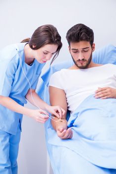 Woman doctor examining male patient in hospital
