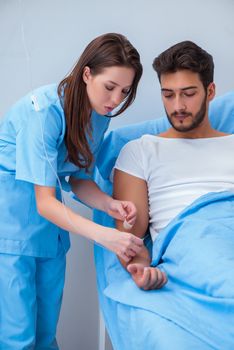 Woman doctor examining male patient in hospital