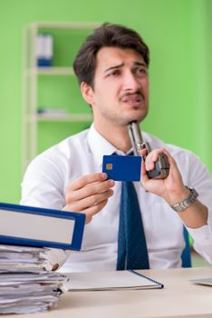 Despaired businessman thinking of suicide in the office 