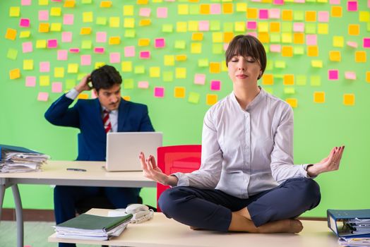 Man and woman in the office with many conflicting priorities in yoga concept  