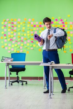 Man in the office with many conflicting priorities preparing go for training