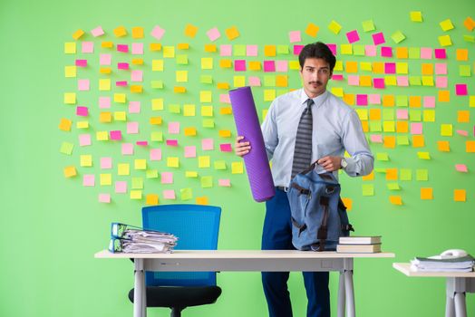 Man in the office with many conflicting priorities preparing go for training