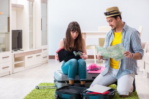 Young family packing for vacation travel