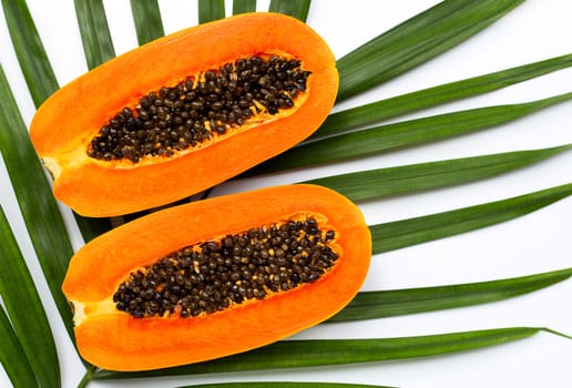 Sweet ripe papaya on tropical palm leaves. Top view