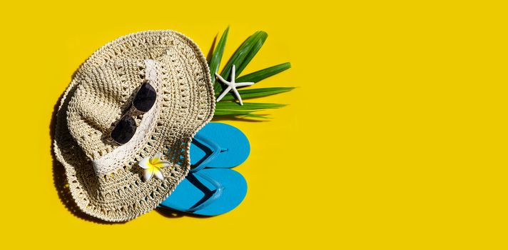 Summer hat with sunglasses on yellow background. Enjoy holiday concept. Copy space