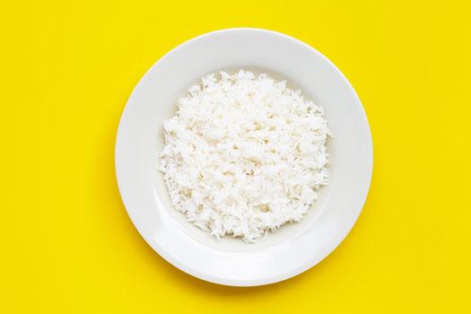 Dish of rice on yellow background. Top view