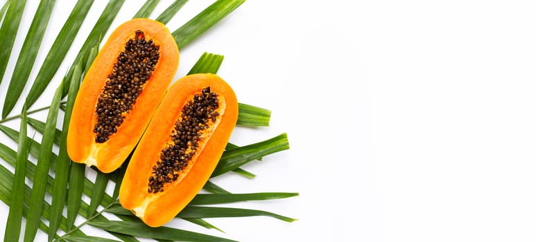 Sweet ripe papaya on tropical palm leaves. Top view