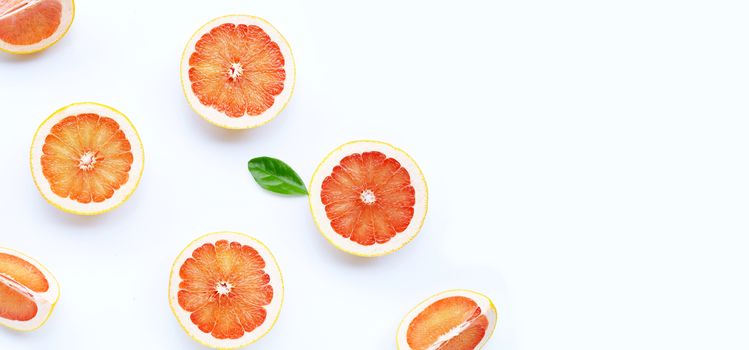 High vitamin C. Juicy grapefruit slices with leaf on white background. Copy space