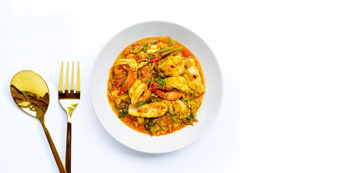 Fried seafood with curry powder on white background.