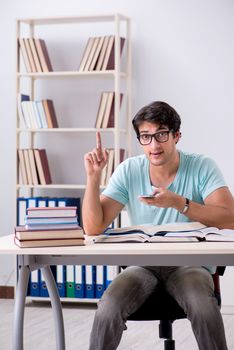 Young handsome student preparing for school exams