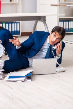 Tired exhausted businessman working overtime in office