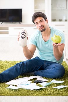 Young man struggling with personal finance and bills