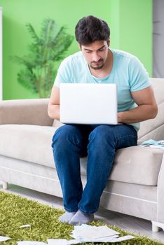 Young man struggling with personal finance and bills
