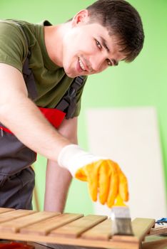 Young man carpenter working in workshop 