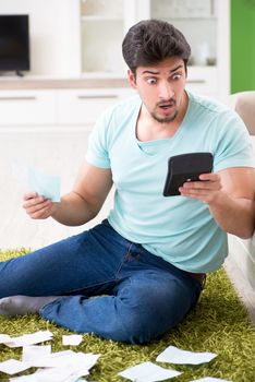 Young man struggling with personal finance and bills