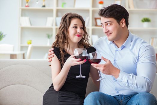 Young pair drinking wine in romantic concept