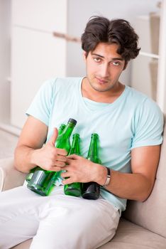 Young drunk handsome man after party at home 