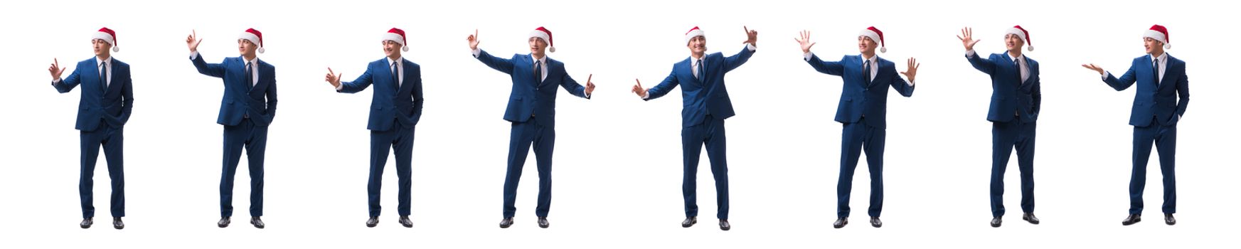 Young busnessman wearing santa hat in christmas concept on white