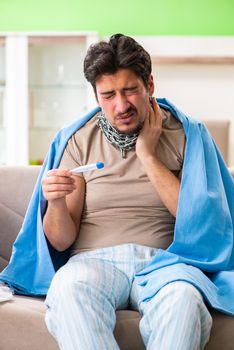 Sick young man suffering from flu at home