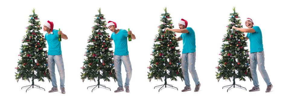 Young man decorating christmas tree isolated on white