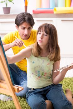 Young couple enjoying painting at home