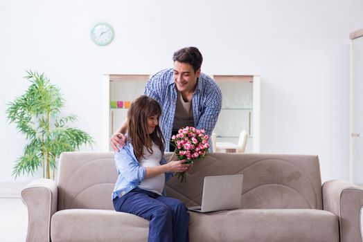 Happy family celebrating pregnancy at home