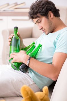 Young drunk handsome man after party at home 