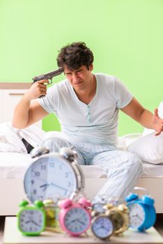 Young man having trouble waking up in early morning