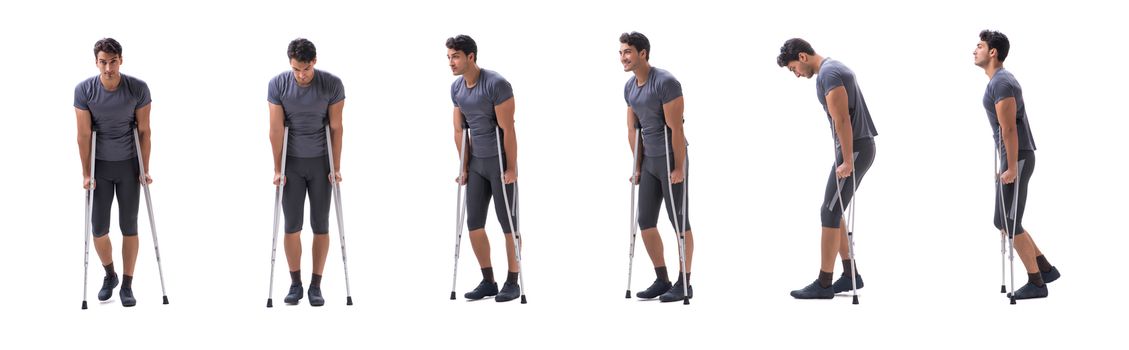 Young patient athlete sportsman suffering an injury trauma with crutches isolated on white