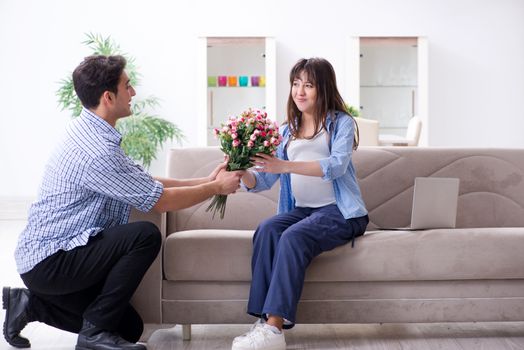 Happy family celebrating pregnancy at home