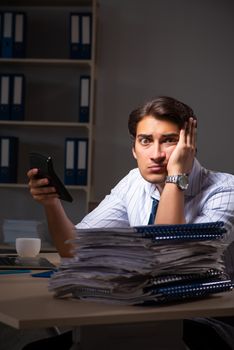 Young financial manager working late at night in office 
