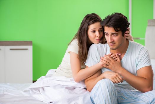 Young woman consoling disappointed impotent husband 