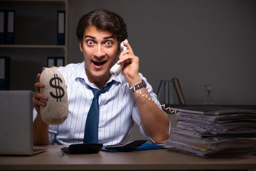 Young financial manager working late at night in office 