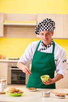 Young man cook preparing cake in kitchen at home 
