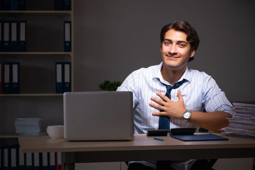 Young financial manager working late at night in office 