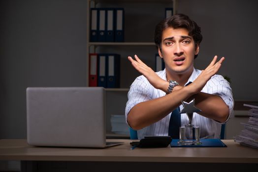 Young financial manager working late at night in office 