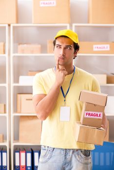 Handsome contractor working in box delivery relocation service 