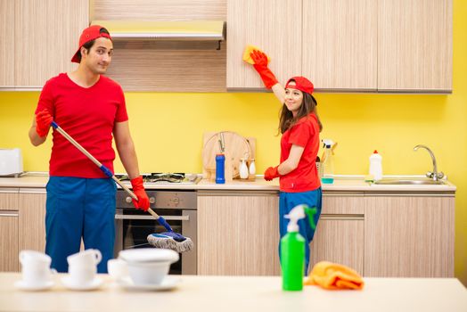 Cleaning professional contractors working at kitchen