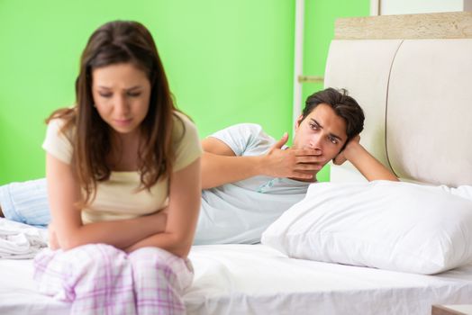 Woman and man in the bedroom after conflict