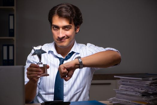 Young financial manager working late at night in office 