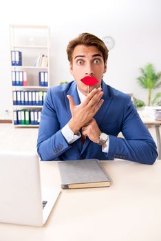 Funny bisinessman with fake lips in the office