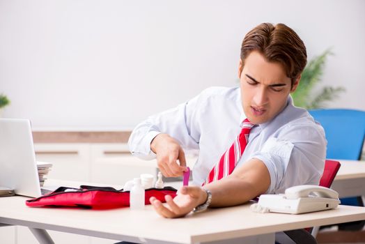 Man with first aid kit in the office