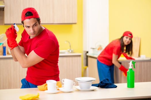 Cleaning professional contractors working at kitchen
