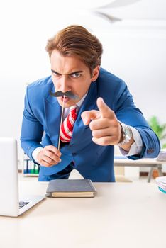 Funny bisinessman with fake moustache in the office
