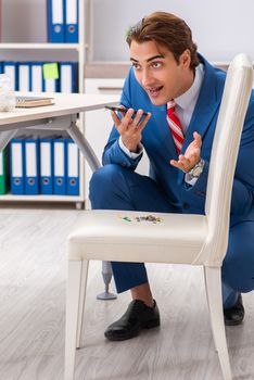 Office prank with sharp thumbtacks on chair